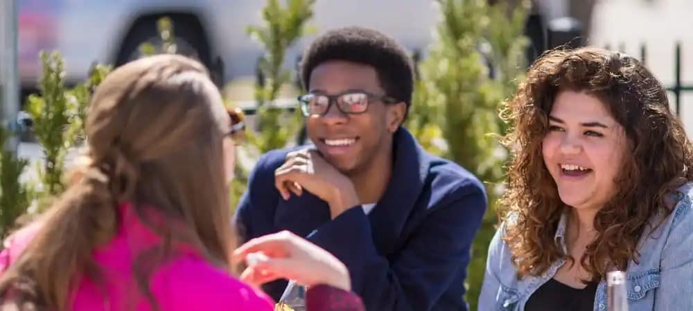 gcu_oncampus-landing_3 Group sitting at table smiling