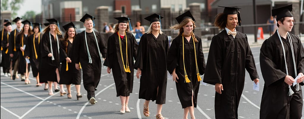 students walking into graduation