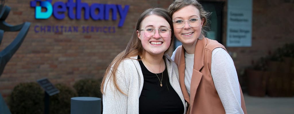 Students taking a photo outside of a building