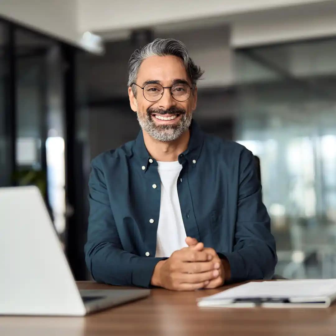 Grace-Online-Student-3 Online Grace student sitting at a desk with a laptop and notebook.
