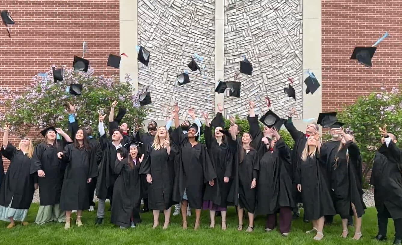 Grace-Graduates-Hat-Toss A group of Grace Graduates tossing their hats in the air.