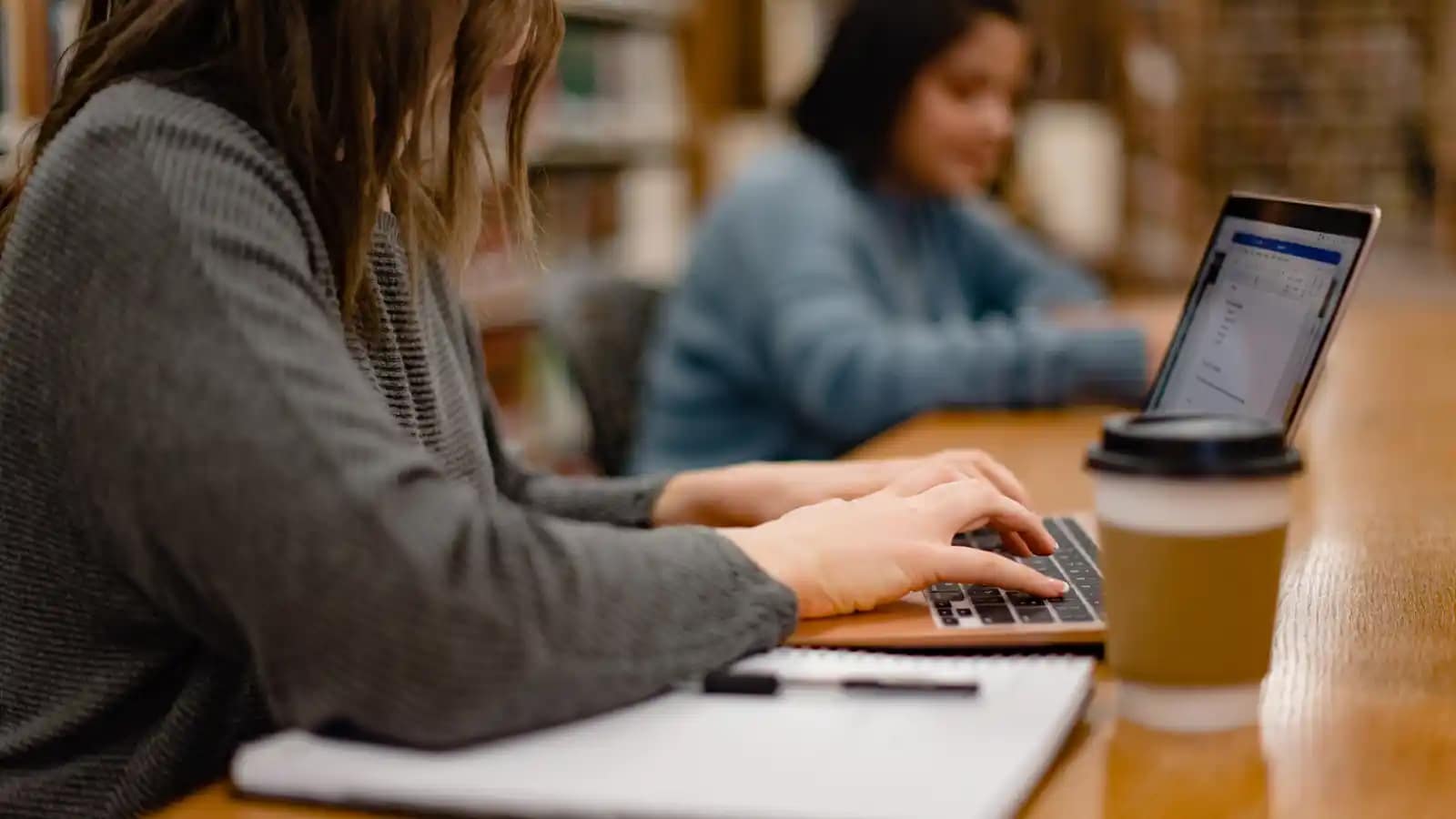 On-Campus-Kickoff-Days-Check-In A student typing on a laptop in the library