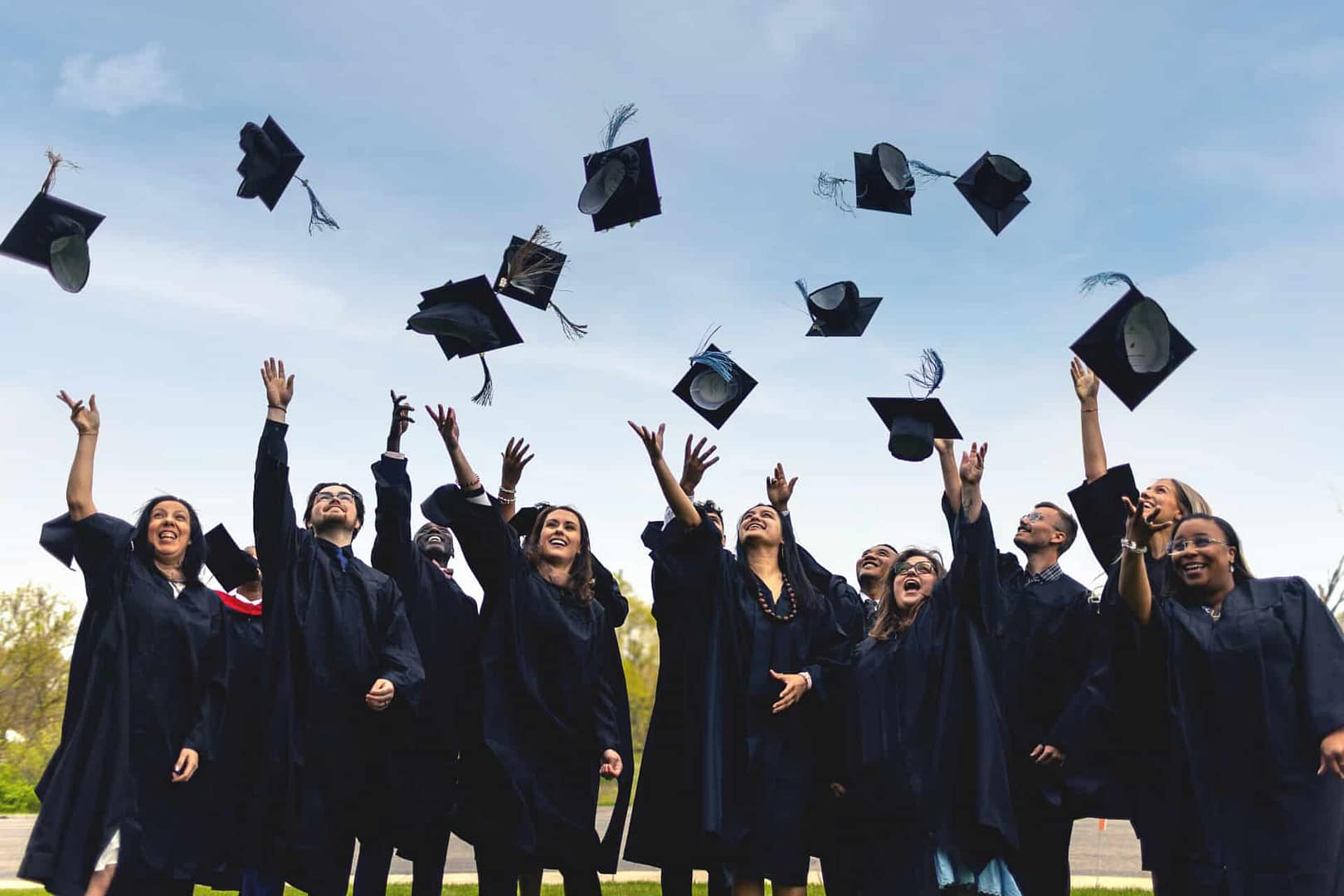 graduates throwing caps in air