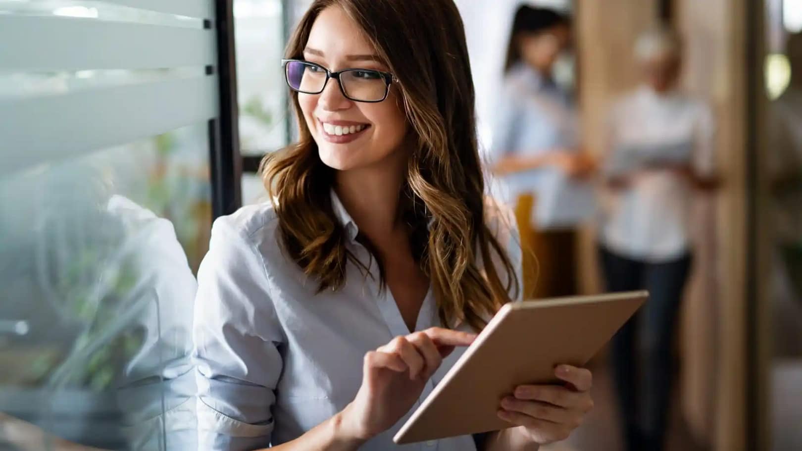 Young Happy Business Woman Working With Tablet In Corporate Office