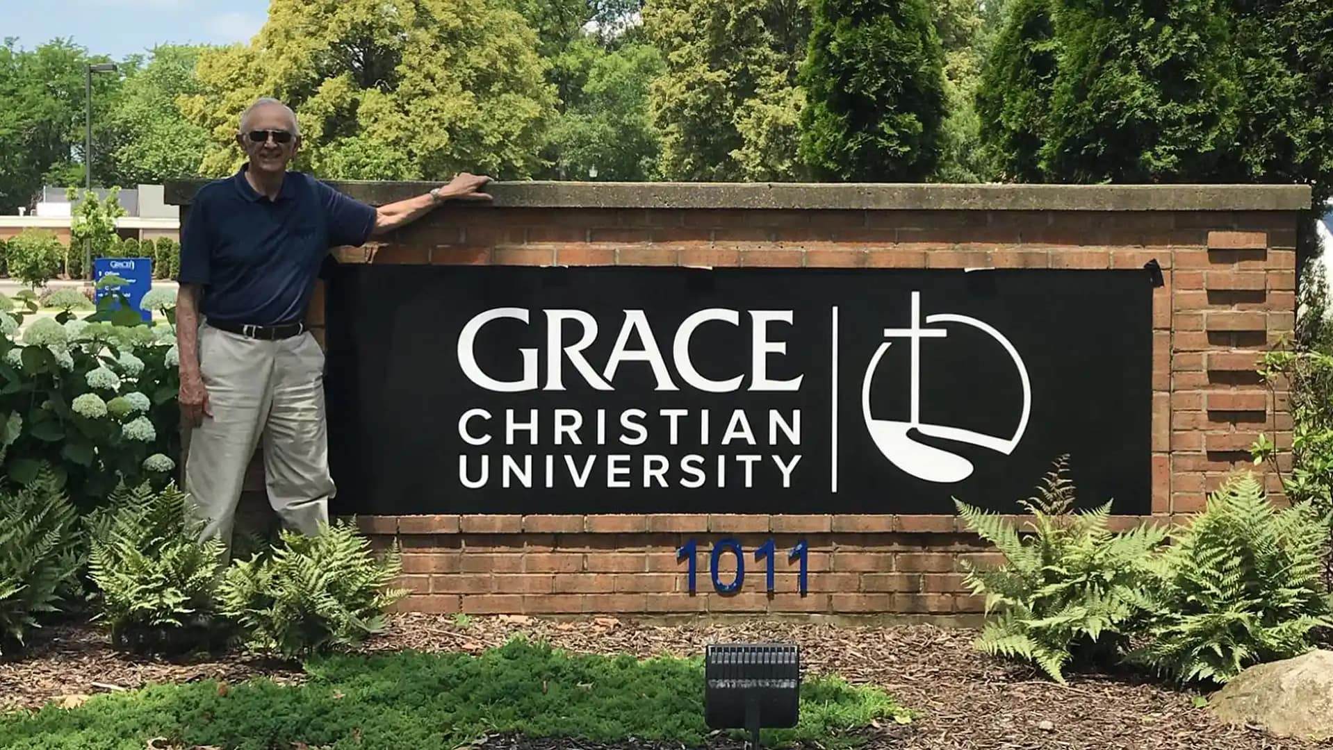 Grace-Entrance-Sign Sam Vinton standing by the Grace Christian University sign at the front entrance.