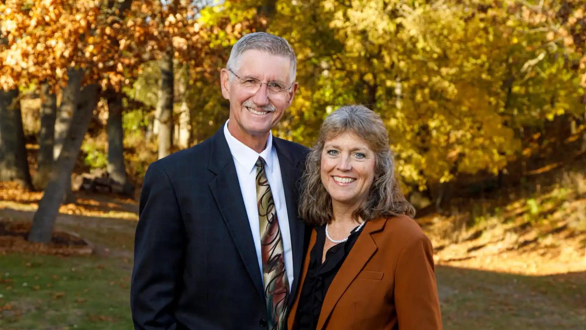 President-Kemper2 President Ken and Kathy Kemper on the grounds of Grace Christian University in fall.