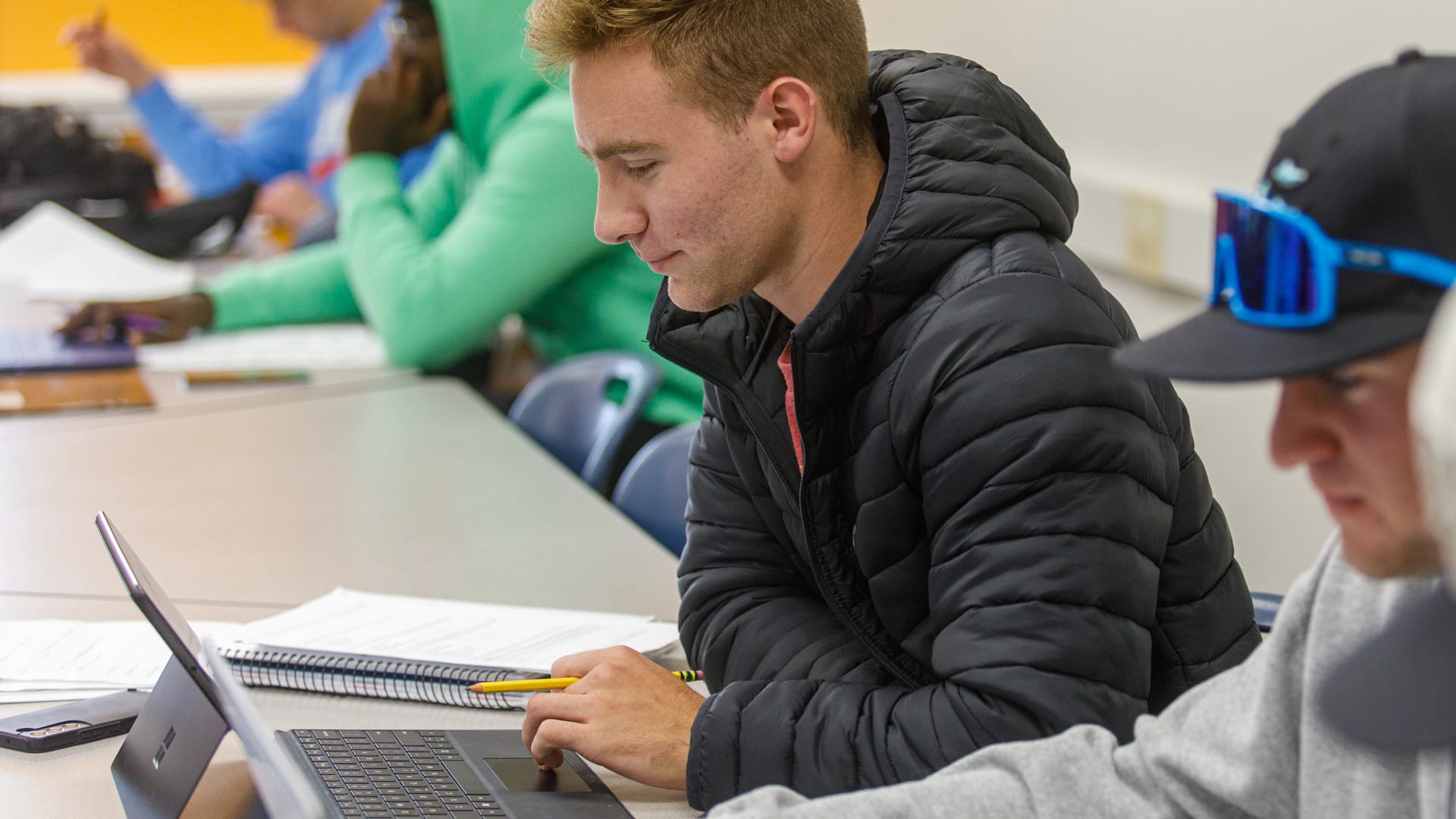 On-Campus-classroom3 Grace student typing on a laptop in a classroom