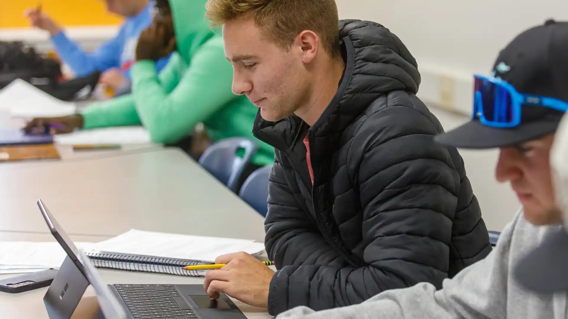 On-Campus-classroom3 Grace student typing on a laptop in a classroom