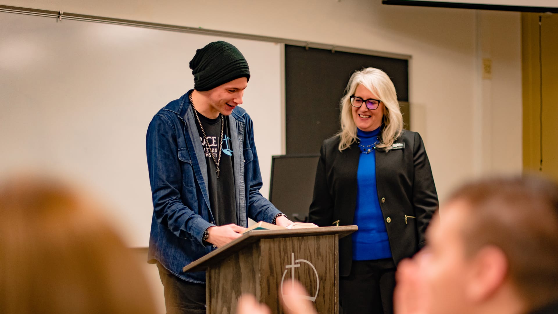 Academic-Catalogs A Grace student and a Professor standing together at the front of a classroom.