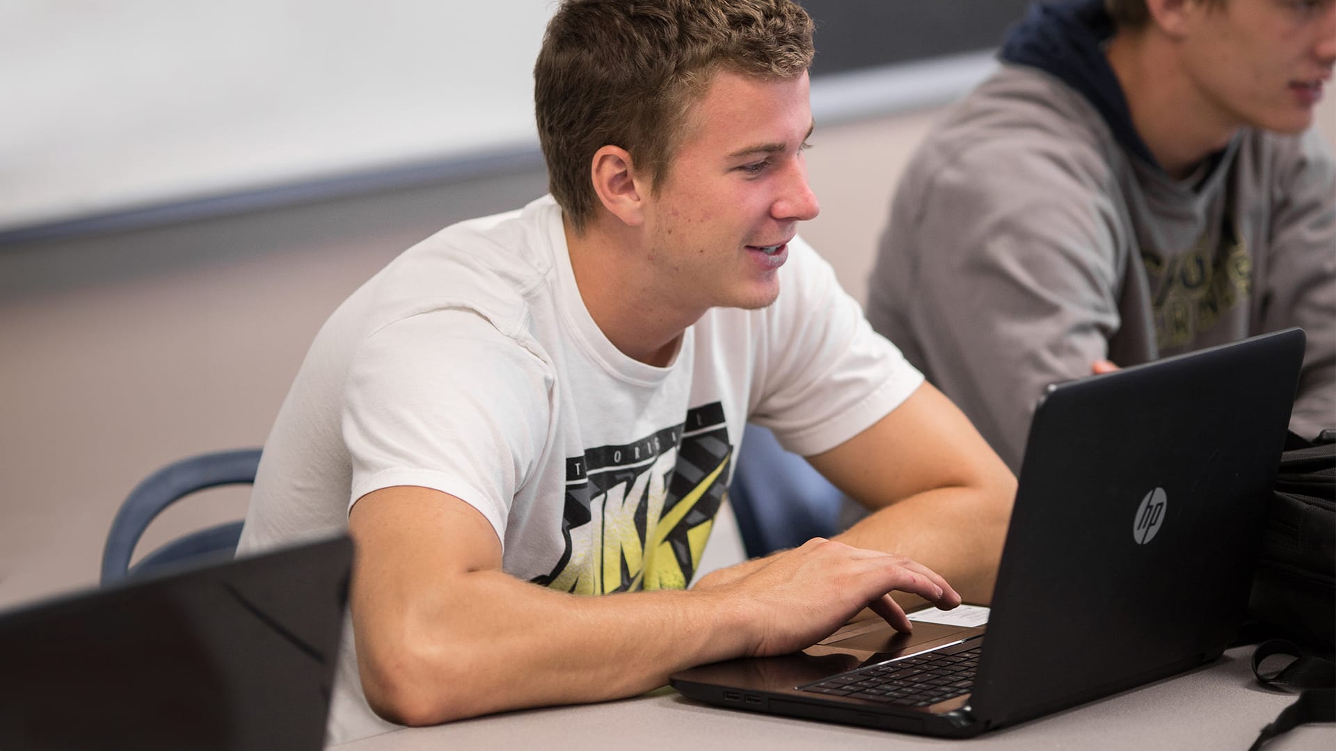 On-Campus-students-classroom1 Grace Students in a classroom with a laptop