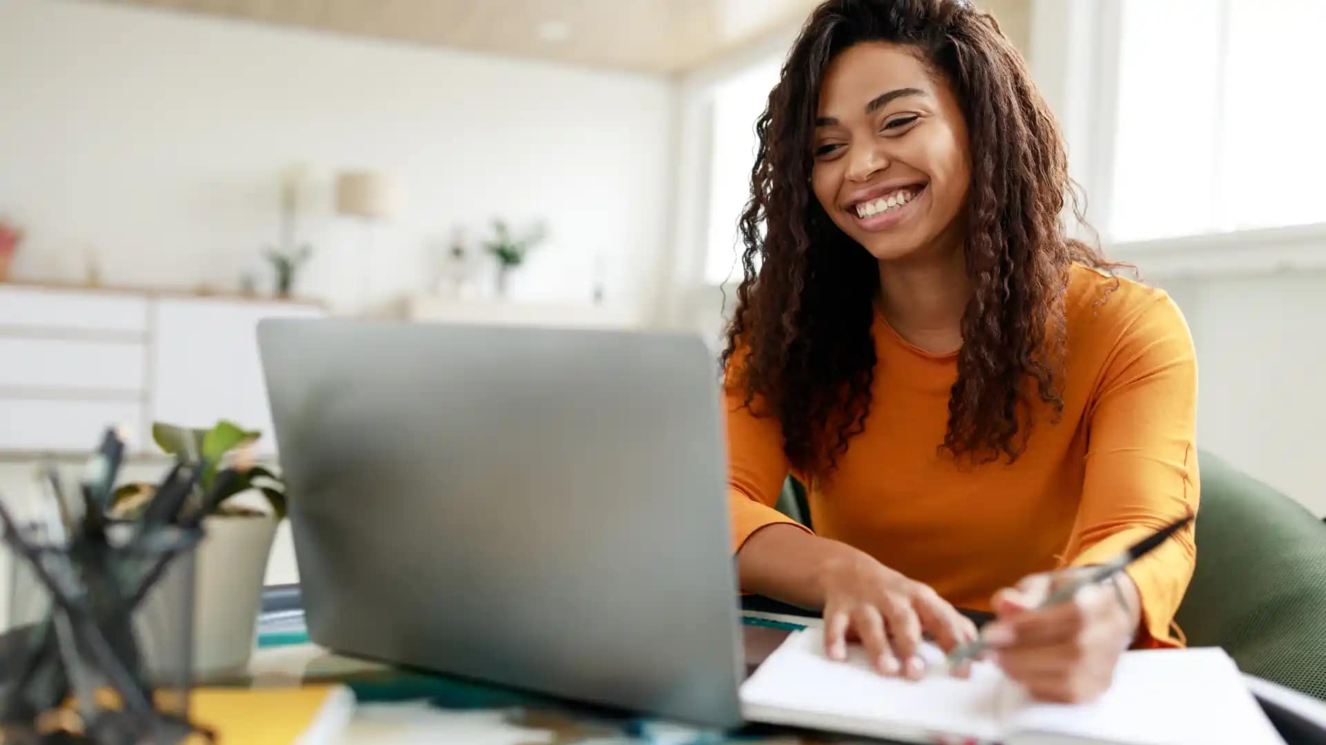 Refer-Someone-to-Grace Happy Grace Online female african american Student working on a laptop.
