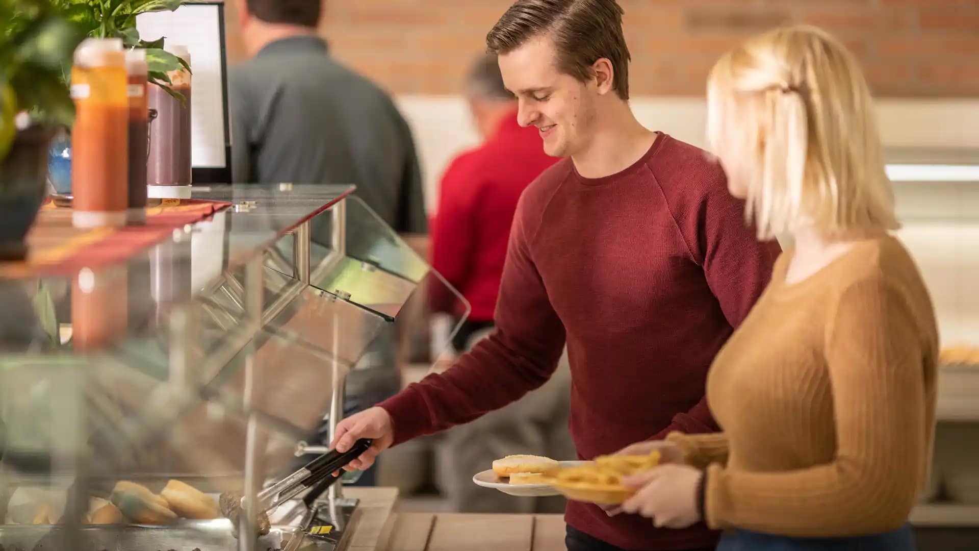 Dining-Services Grace students serving lunch in the cafeteria, in the Dining Hall at Grace Christian University.