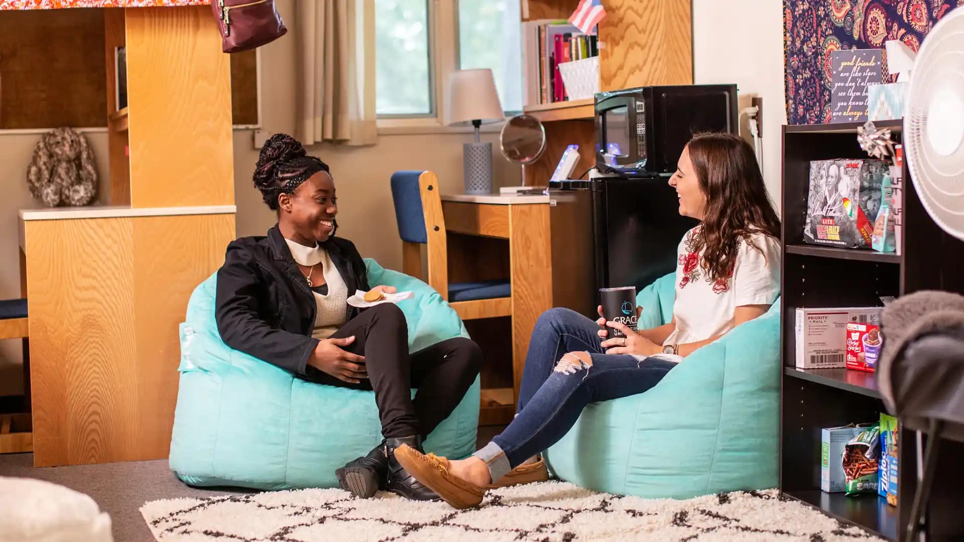Residence-Hall Two Happy Grace Students having a conversation, sitting on bean bags in a Residence Hall, Grace Housing, Dorm