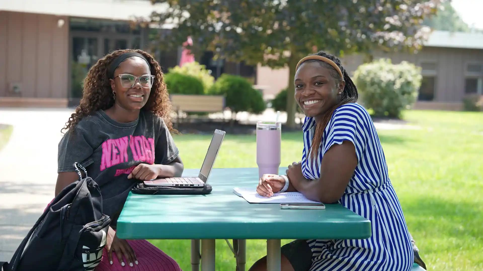 Grace-On-Campus-Students-11 A couple of Grace students studying at an outdoor bench
