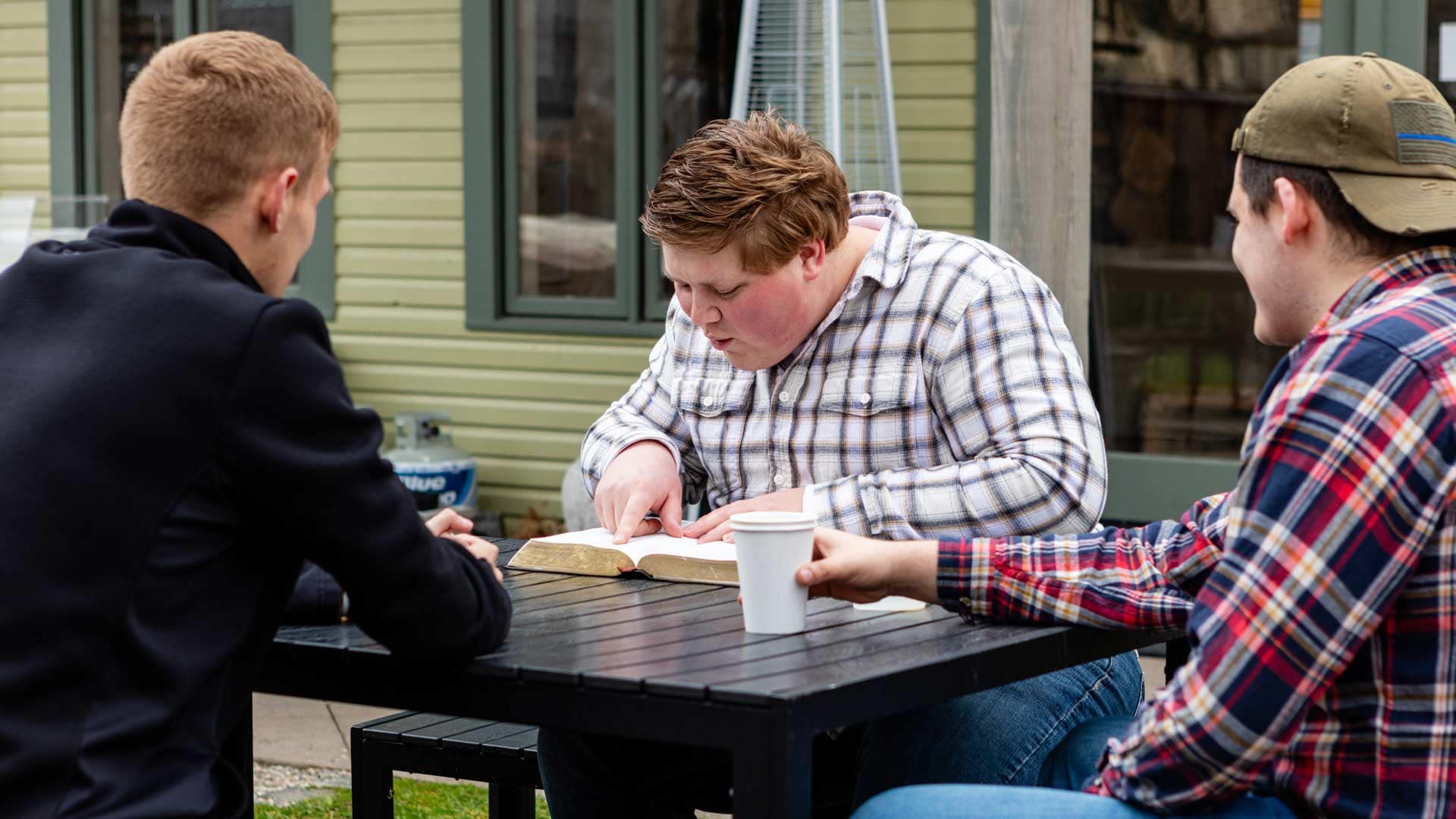 Grace-On-Campus-Students-5 Grace students sitting outside doing a bible study