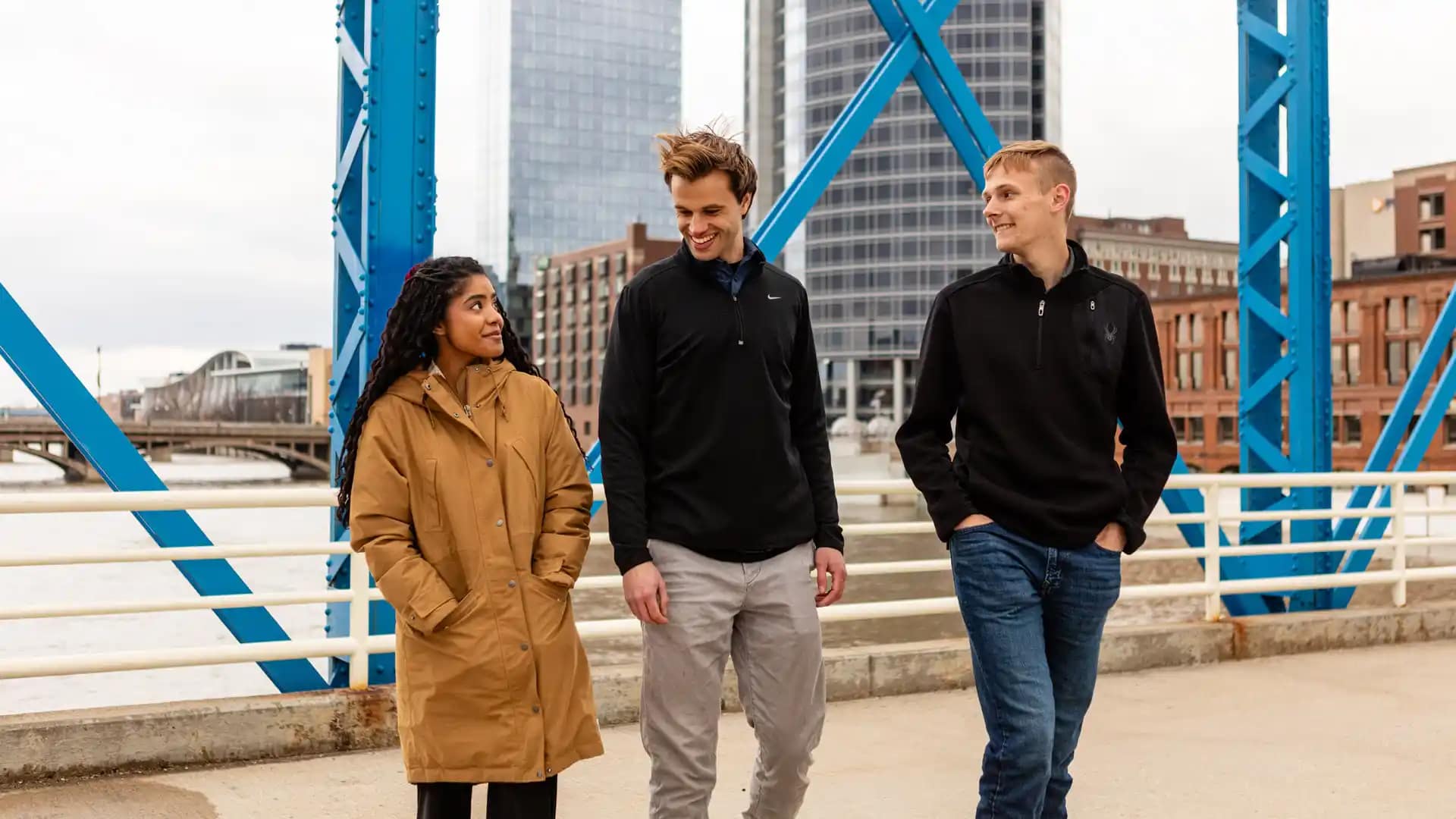 Grace-On-Campus-Students-12 A group of happy Grace students walking on a bridge in Grand Rapids, Michigan