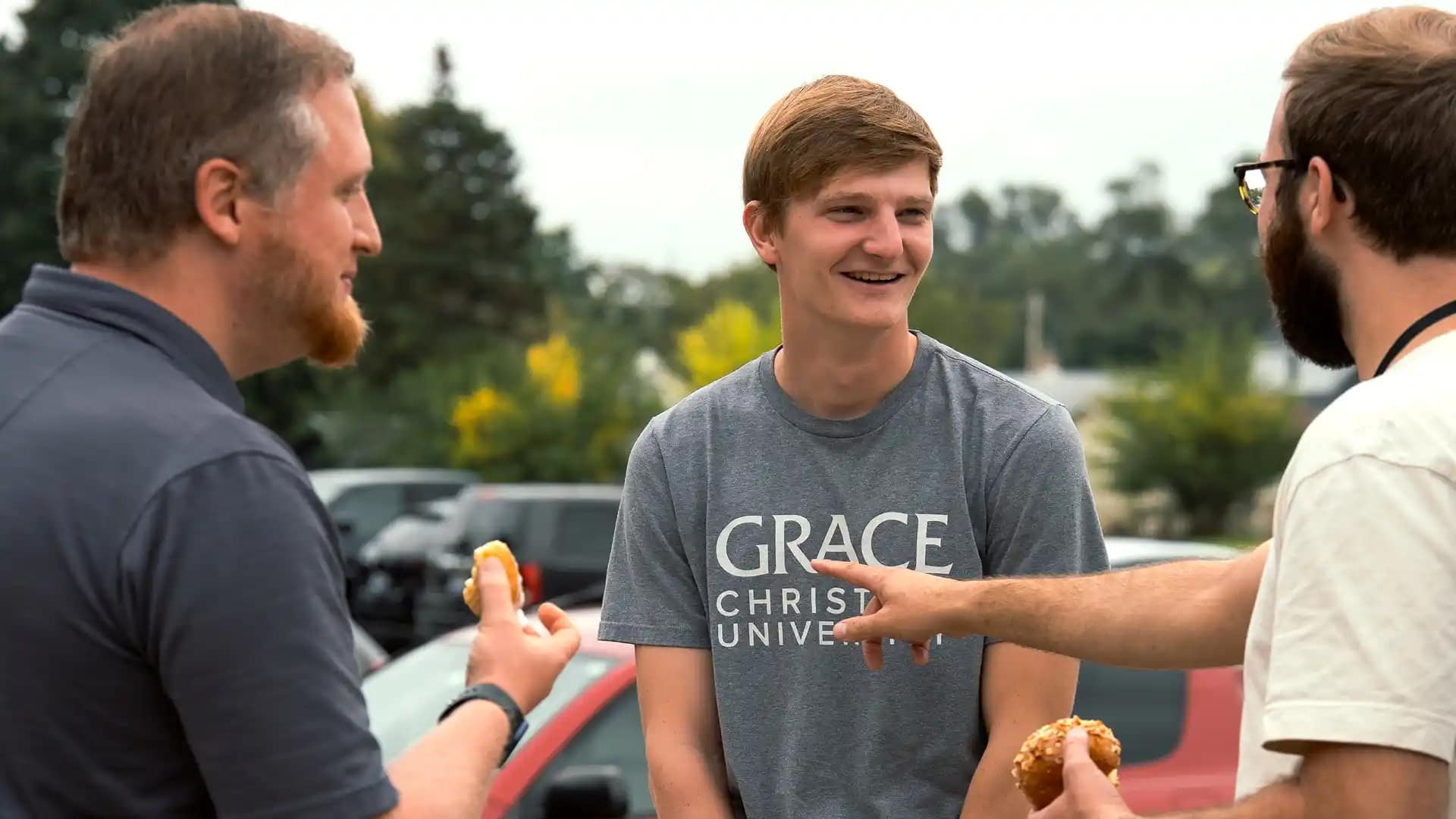 Homecoming Grace alumni talking at a Homecoming event